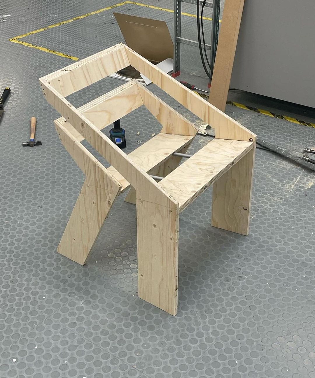 A woodworker's creation in progress, featuring a partially assembled wooden workbench