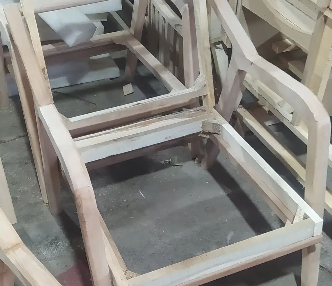 A bare wooden chair frame in a workshop