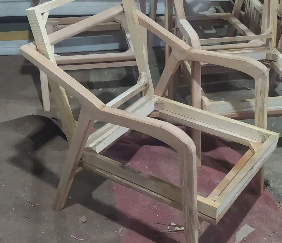 Unfinished wooden chair frames in a workshop