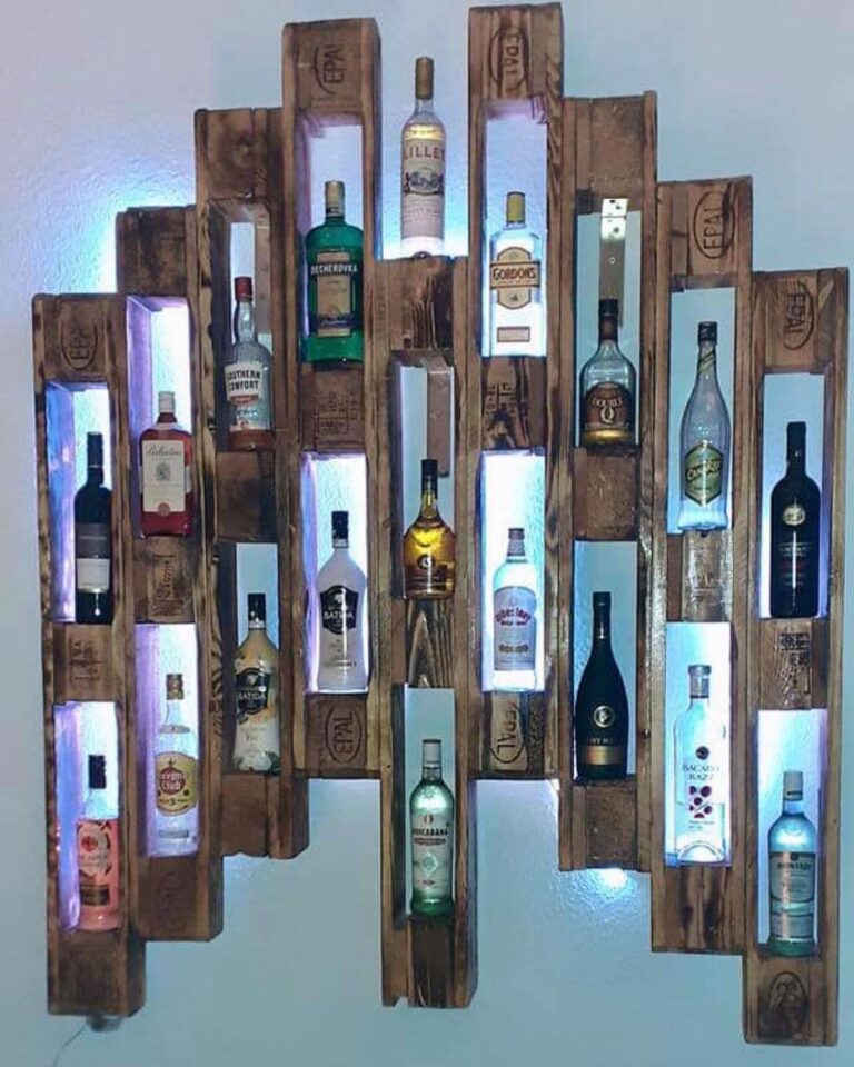 A rustic wooden pallet bar shelf featuring illuminated nooks with assorted liquor bottles